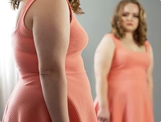 Woman looking at mirror.